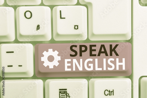 Writing note showing Speak English. Business concept for Study another Foreign Language Online Verbal Courses White pc keyboard with note paper above the white background photo