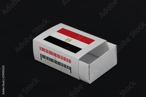 Egypt flag on white box with barcode and the color of nation flag on black background, paper packaging for put match or products. photo