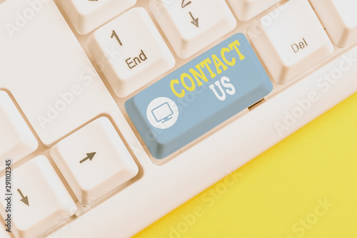 Text sign showing Contact Us. Business photo showcasing Group of demonstrating that rendering costumer service through telecom White pc keyboard with empty note paper above white background key copy photo