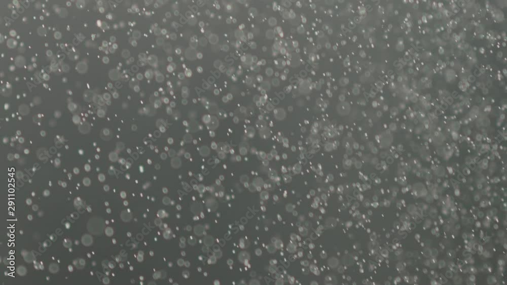Slow motion of fine dust particles falling on black background Slow motion of fine dust particles falling on black background