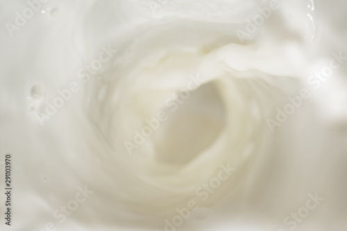 Soft pouring spinning stream of milk is close