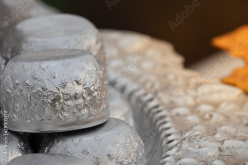 A lot of small water bowls in big water bowl to spinkle water with buddha statue in Songkran festival. photo