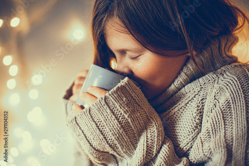 girl child in sweater with cup, cozy , toning © natalialeb