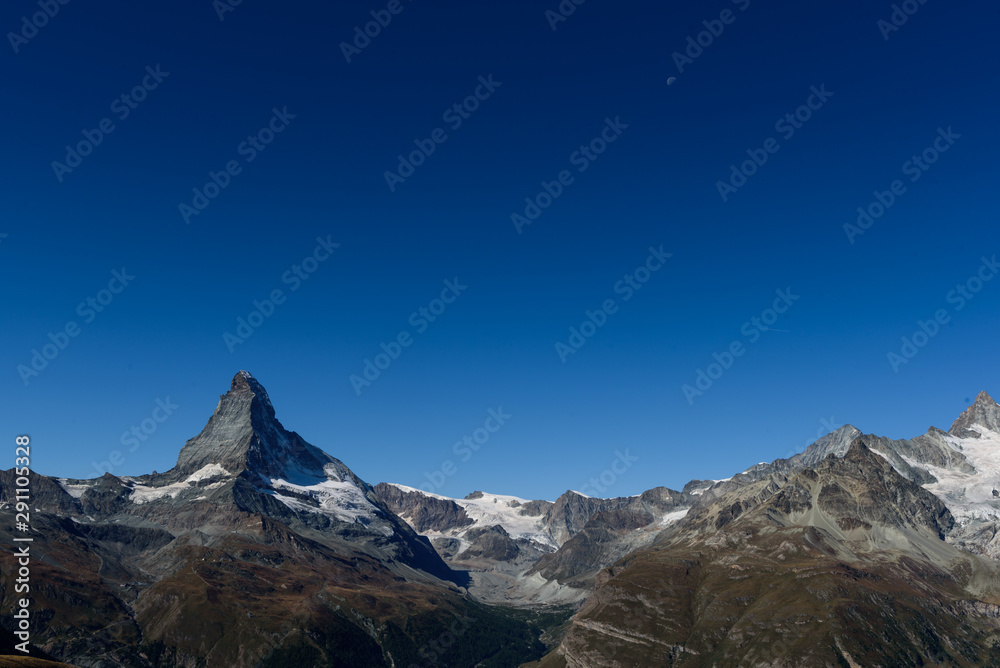 Amazing View of the mountain Matterhorn, Zermatt, Valais in the Swiss Alps, blue sky, no clouds in early autumn.