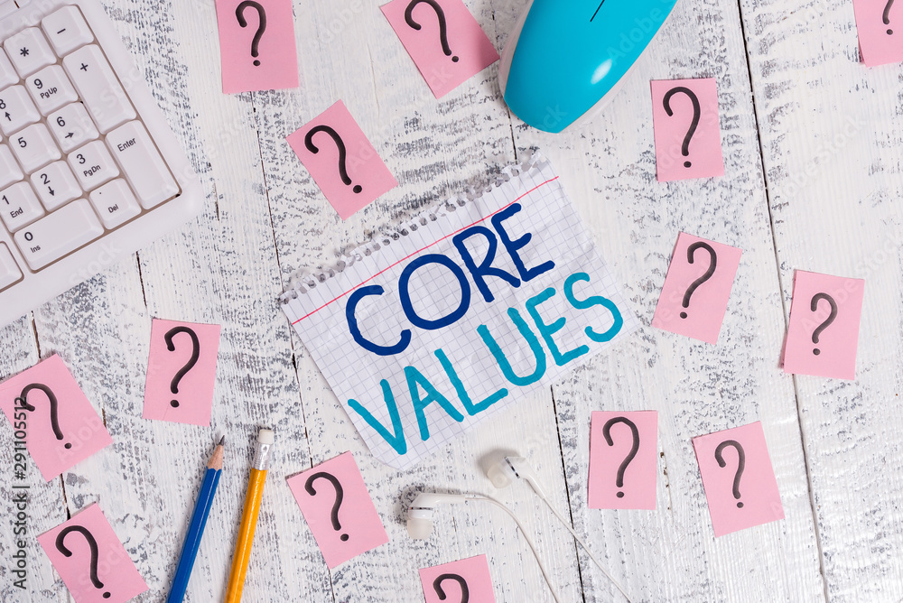 Writing note showing Core Values. Business concept for belief demonstrating or organization views as being importance Writing tools and scribbled paper on top of the wooden table Writing note showing Core Values. Business concept for belief demonstrating or organization views as being importance Writing tools and scribbled paper on top of the wooden table