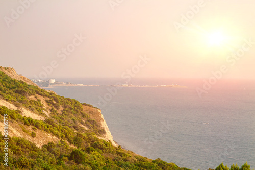 Evening over a high and steep seashore.