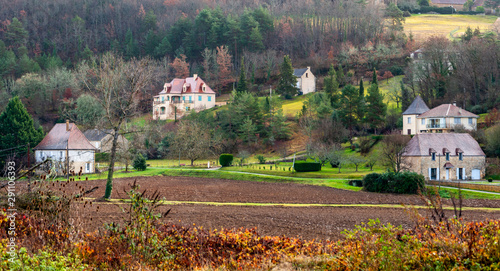 Belves, in the Dordogne-Périgord region in Aquitaine, France. Medieval village with typical houses perched on the hill, among pastures and green countryside. photo