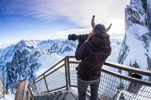 Woman with viking hat taking pictures in the French Alps.  photo