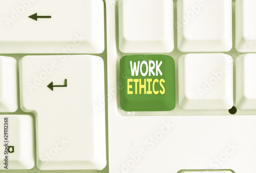 Conceptual hand writing showing Work Ethics. Concept meaning A set of values centered on the importance of doing work White pc keyboard with note paper above the white background photo