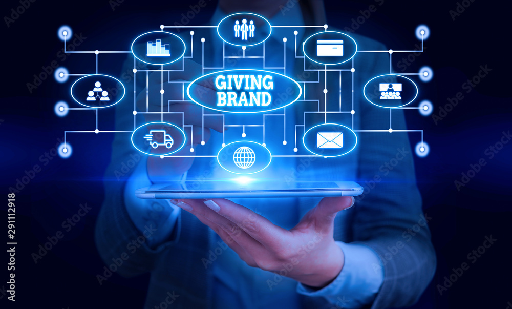 Conceptual hand writing showing Giving Brand. Concept meaning The process of giving a Name to a company products or services Woman wear work suit presenting presentation smart device