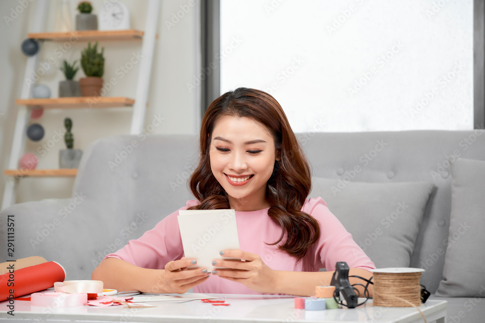 Valentine day theme. Beautiful romantic woman making present for her couple Valentine day theme. Beautiful romantic woman making present for her couple