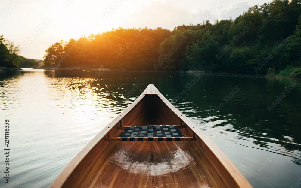 Canoe bow seat and deck on the sunset lake - obrazy, fototapety, plakaty 