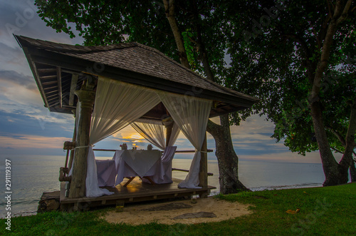 Romantic pavilion at evening time with dim light. It's a nice place at beachfront for dinner.