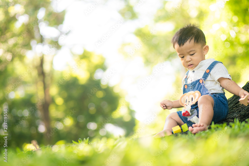 Kid child boy enjoying with nature green grass under tree Kid child boy enjoying with nature green grass under tree