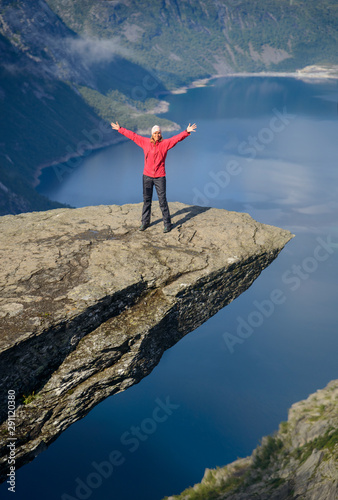 Happy tourist on Troll tongue (Trolltunga)