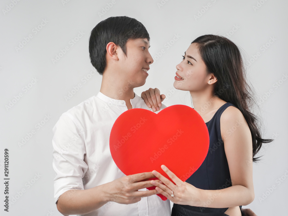 Happy couple in love holding red heart shape, valentine concept. Happy couple in love holding red heart shape, valentine concept.