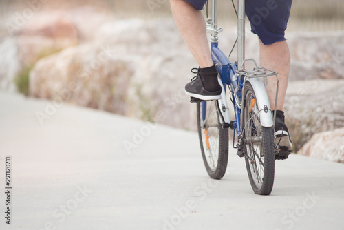 senior strolling with his folding bike
