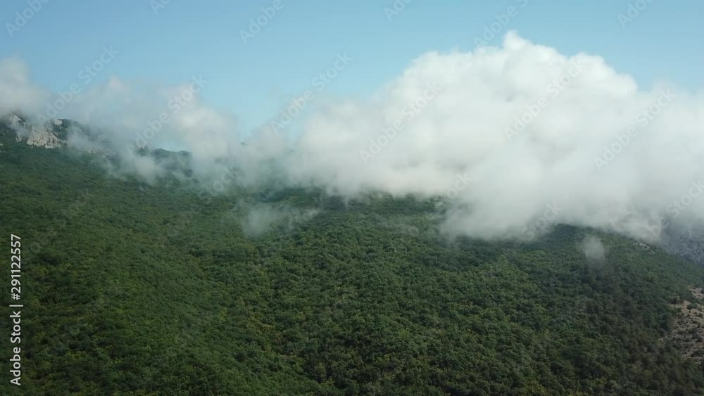 Crimea with Beautiful View of Mountains and highway road between the mountains. Aerial View Of Fast Rolling Clouds Drifting Over mountains and hills. Crimea with Beautiful View of Mountains and highway road between the mountains. Aerial View Of Fast Rolling Clouds Drifting Over mountains and hills.