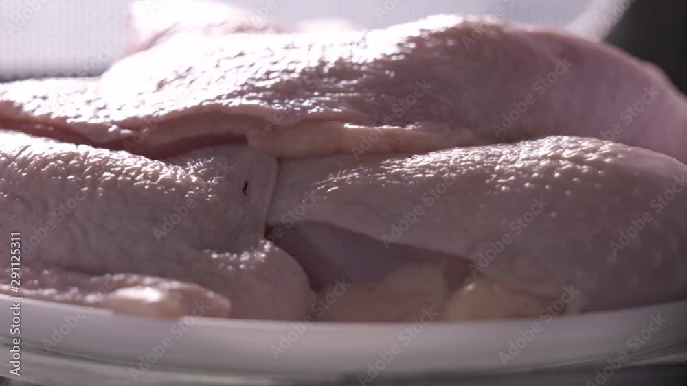 Raw boneless chicken legs rotating in microwave defrosting. Raw boneless chicken legs rotating in microwave defrosting.
