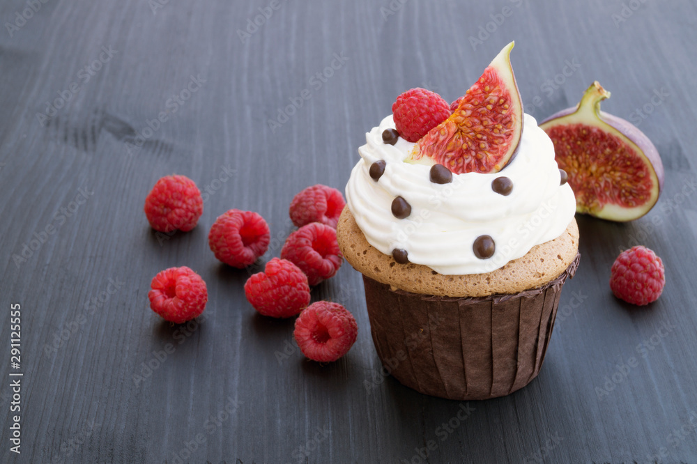 Chocolate cake with figs and raspberries on a black background. Chocolate cake with figs and raspberries on a black background.