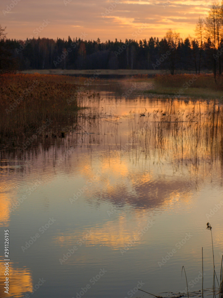 Fototapeta premium picture with abstract and colorful sky reflections in water, suitable for textures