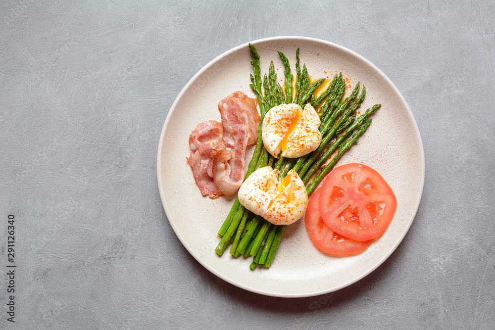 Benedict poached eggs with bacon and fried asparagus for breakfast Benedict poached eggs with bacon and fried asparagus for breakfast