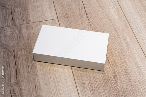 White cardboard box isolated on wooden surface, mock up