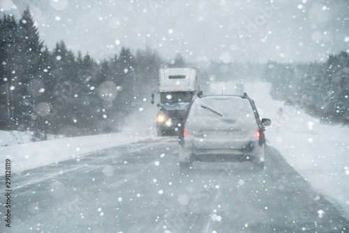 The car is driving on a winter road in a blizzard  © scharfsinn86