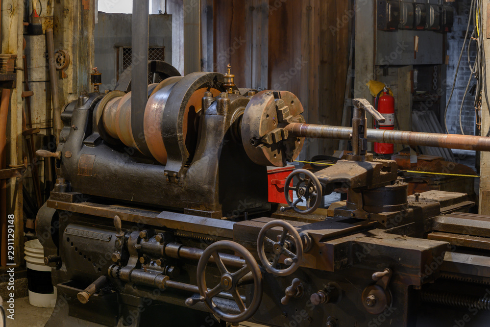 belt driven steel lathe in old workshop 