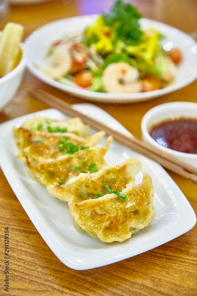 Have gyoza or fried dim sums are on a plate in the restaurant