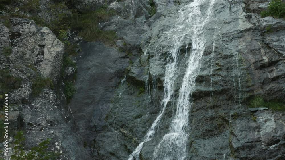 Rough and beautiful mountain stream waterfall on carved gray rocks close up Rough and beautiful mountain stream waterfall on carved gray rocks close up