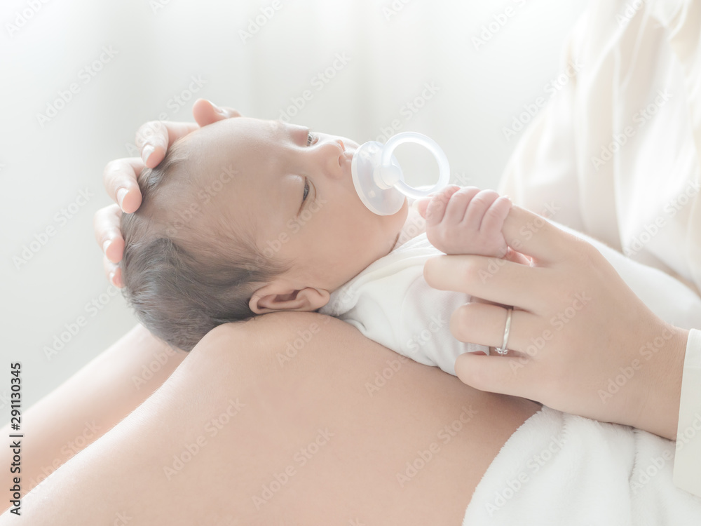 A beautiful Asian woman puts her newborn baby on her body A beautiful Asian woman puts her newborn baby on her body