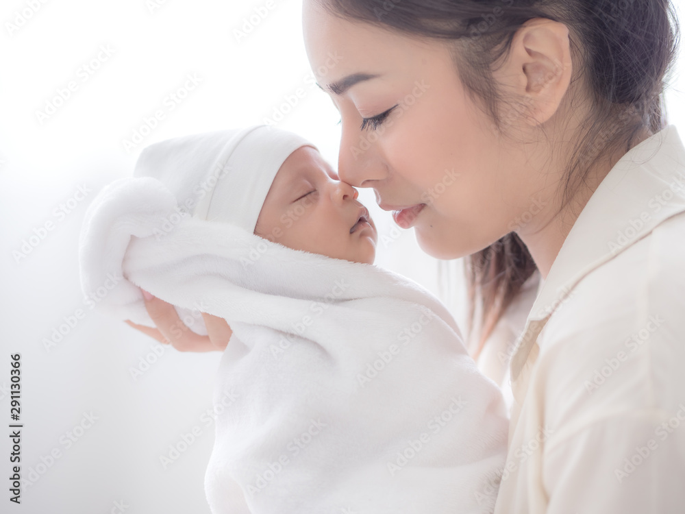 A beautiful Asian woman carried her newborn baby with happiness A beautiful Asian woman carried her newborn baby with happiness
