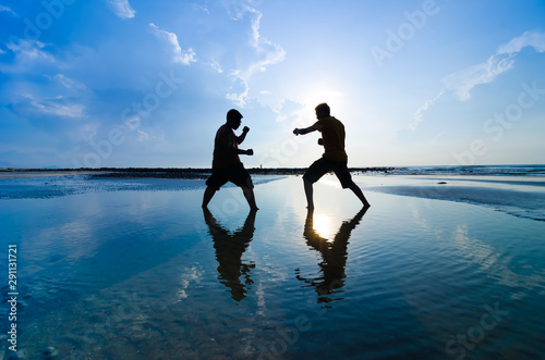 Fighting an enemy near the beach when the sun rising up