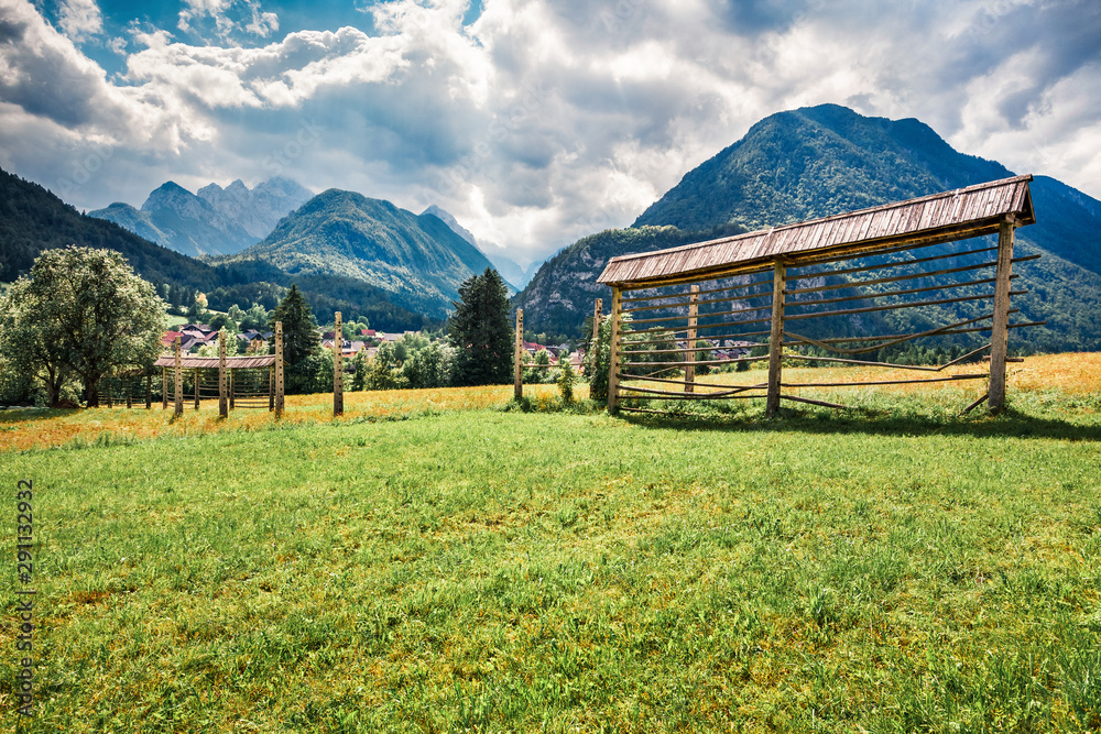 Picturesque summer view of Triglav mountain range and  Gozd Martuljek village. Sunny morning scene of Julian Alps, Slovenia, Europe. Instagram filter toned. Artistic style post processed photo.