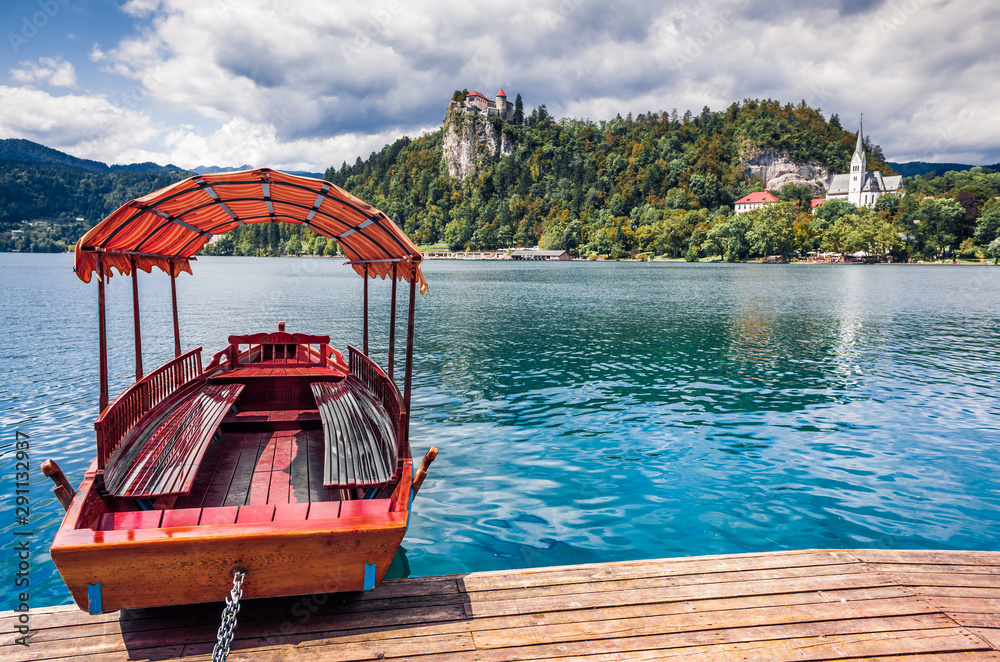 Attractive summer view of Lake Bled (Blejsko jezero) is a glacial lake in the Julian Alps in northwestern Slovenia. Sunny morning scene of Bled town and is overlooked by Bled Castle.
