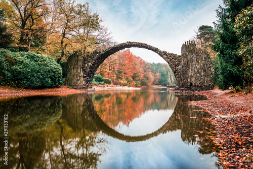 Fototapeta Naklejka Na Ścianę i Meble -  Fantastic morning scene of Azalea and Rhododendron Park Kromlau, Germany, Europe. Splendid autumn view of Rakotz Bridge (Rakotzbrucke, Devil's Bridge). Instagram filter toned.