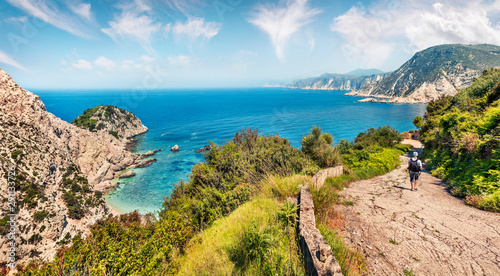Fototapeta Naklejka Na Ścianę i Meble -  Old road to Agia eleni beach. Sunny morning seascape of Mediterranean Sea. Colorful outdoor scene of Cephalonia island, Greece, Europe. Traveling on Ionian Islands.