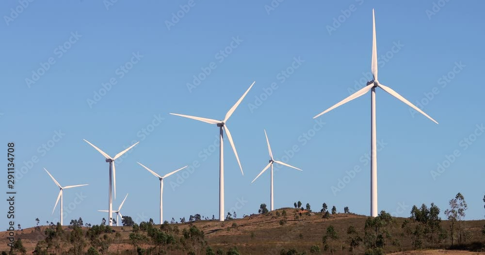 Wind park with wind turbines under the blue sky. Renewable energy production for the green environmental world - aerial view with a drone - environment & ecological concept Wind park with wind turbines under the blue sky. Renewable energy production for the green environmental world - aerial view with a drone - environment & ecological concept
