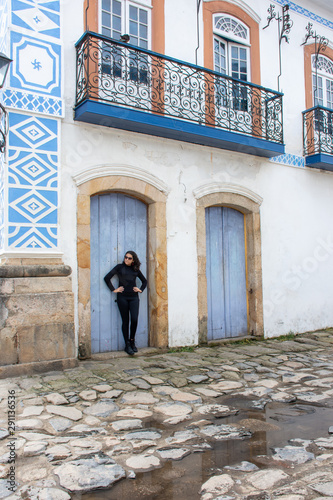 Young teenage girl in black makes pose on the street with interesting scenery © Rogerio