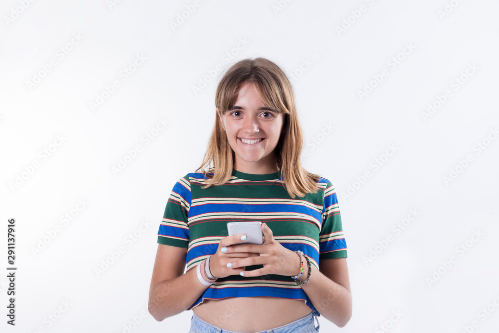 Portrait of a happy young woman using smartphone over white background Portrait of a happy young woman using smartphone over white background