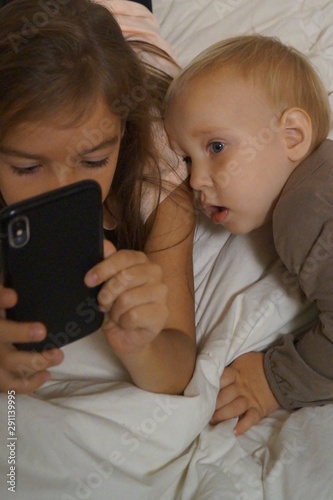 girls playing with mobile telephone