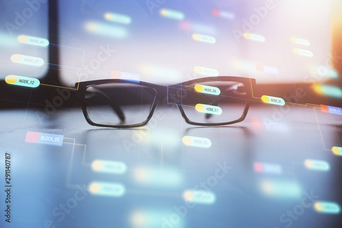 Data tech hologram with glasses on the table background. Concept of technology. Double exposure. © peshkova