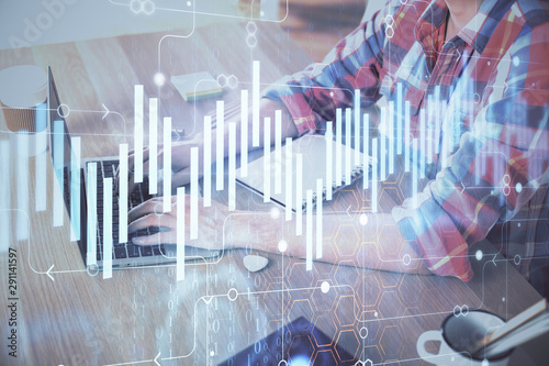 Multi exposure of forex graph with man working on computer on background. Concept of market analysis.