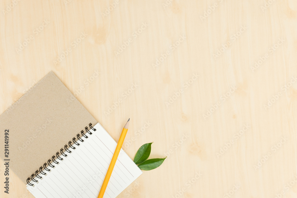 yellow pencil with notebook on wooden desk,flat lay. Top view. yellow pencil with notebook on wooden desk,flat lay. Top view.