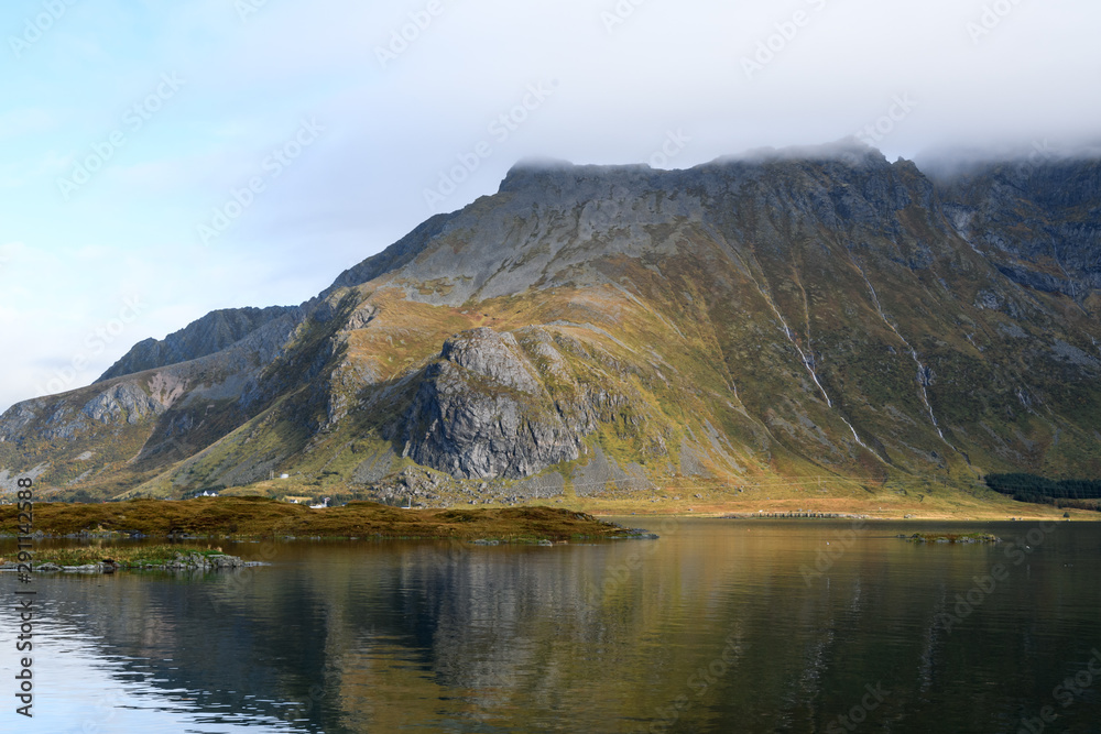 Mirror reflection of mountain in a lake in lofoten islands, Norway. Concept of reflection, peace, nature, calm, meditation.