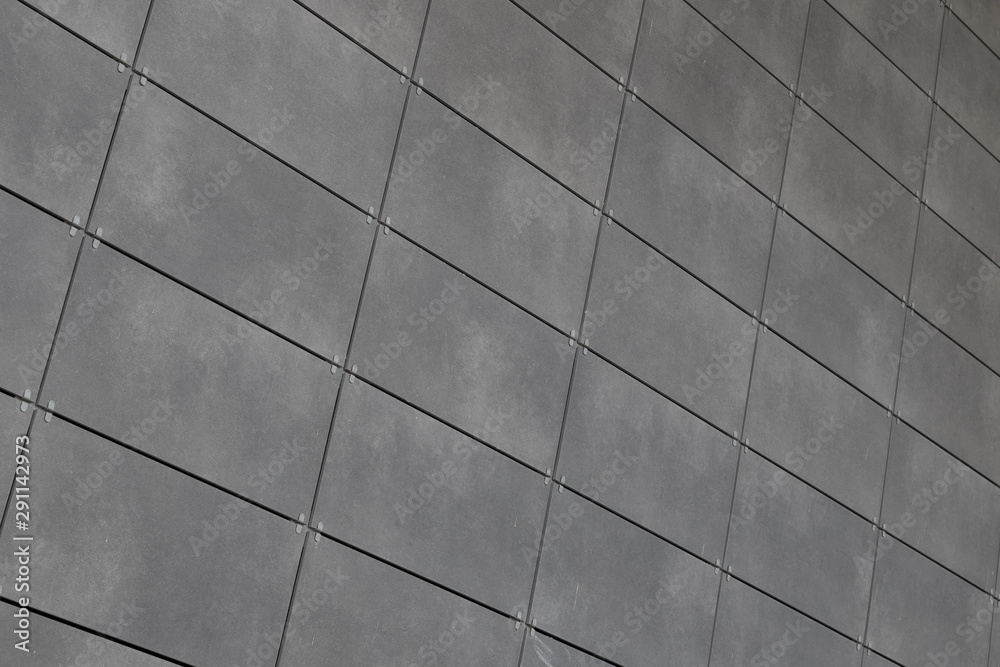 Angle view of modern just placed gray ceramic tiles with dark joint. Backdrop, texture or pattern for design. Angle view of modern just placed gray ceramic tiles with dark joint. Backdrop, texture or pattern for design.