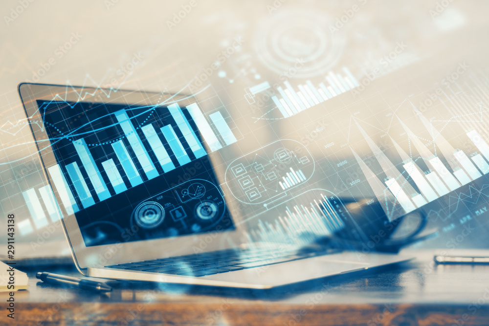 Stock market chart hologram drawn on personal computer background. Multi exposure. Concept of investment. Stock market chart hologram drawn on personal computer background. Multi exposure. Concept of investment.