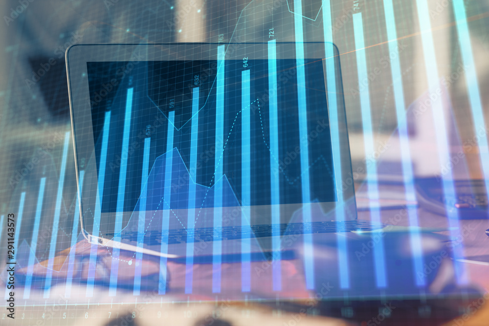 Forex Chart hologram on table with computer background. Double exposure. Concept of financial markets. Forex Chart hologram on table with computer background. Double exposure. Concept of financial markets.