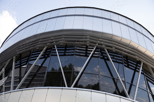Ground view of hemispheric black glass windows reflecting street